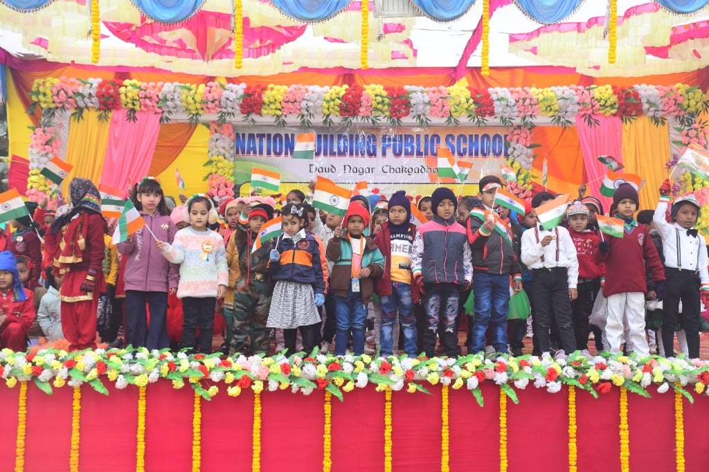 Students on stage with flags