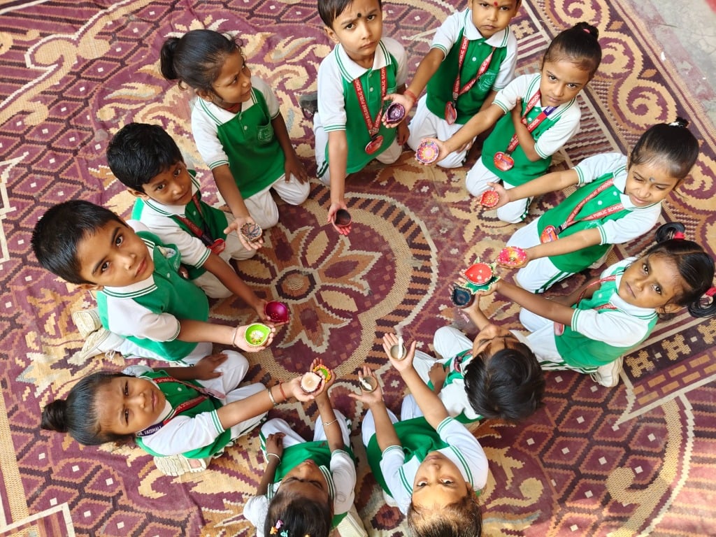 Students looking up with Diyas